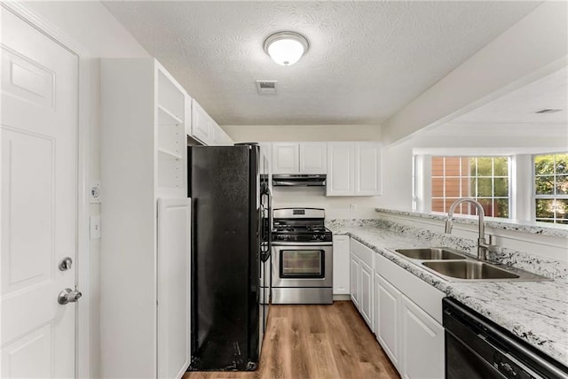 kitchen with visible vents, a sink, black appliances, and white cabinetry