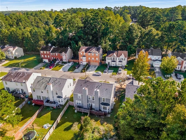 drone / aerial view featuring a forest view and a residential view