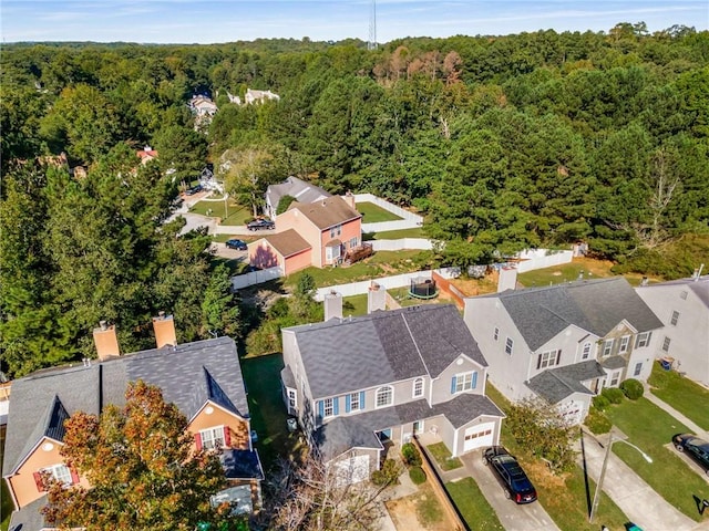 drone / aerial view with a residential view and a wooded view