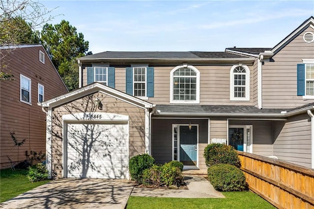 view of front of home with fence and driveway