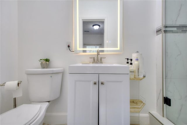 bathroom featuring vanity, toilet, and tiled shower