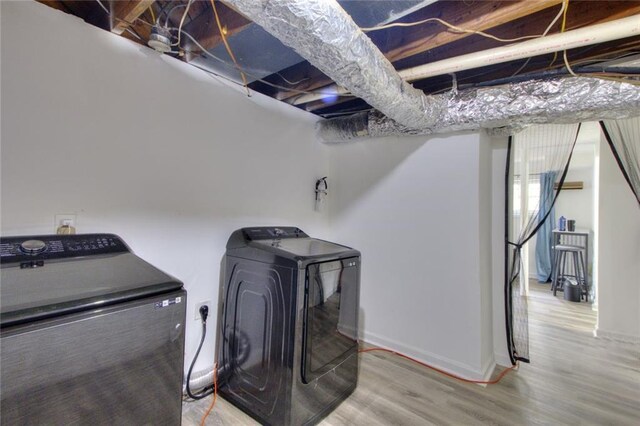 washroom featuring washer and clothes dryer and hardwood / wood-style flooring