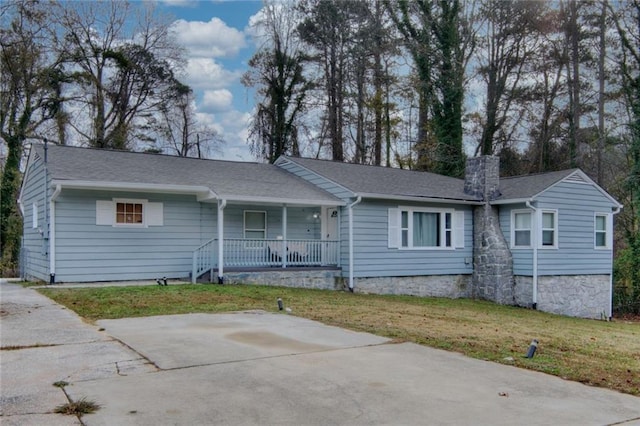 ranch-style house with a front yard and a porch