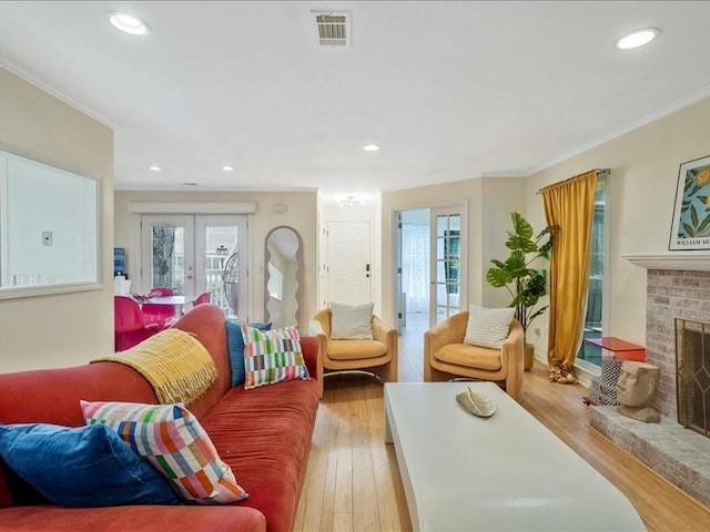 212 Abingdon Way, Atlanta, GA 30328 - living room with french doors, plenty of natural light, wood finished floors, crown molding, and a brick fireplace