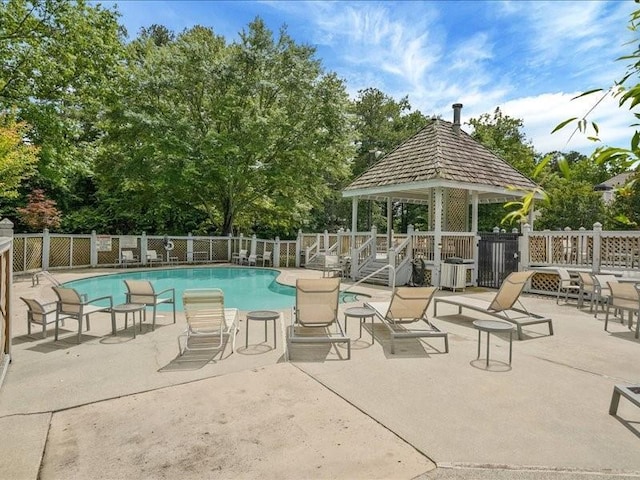 212 Abingdon Way, Atlanta, GA 30328 - community pool featuring a gazebo, a patio, and view of scattered trees