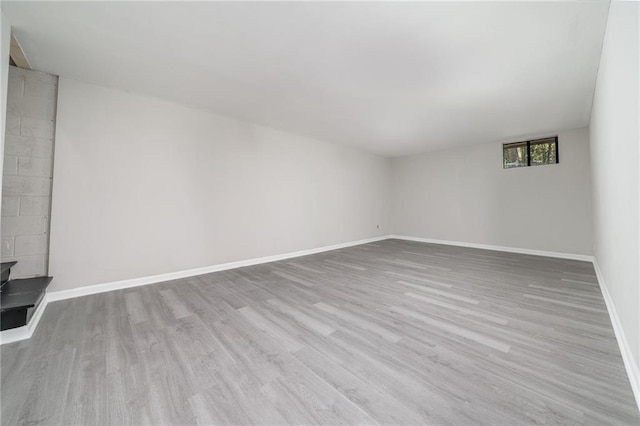 empty room with light wood finished floors and baseboards