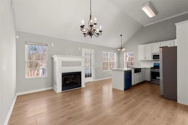 kitchen featuring pendant lighting, white cabinetry, stainless steel appliances, light hardwood / wood-style floors, and kitchen peninsula