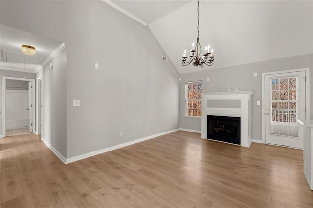 unfurnished living room with hardwood / wood-style flooring, crown molding, a chandelier, and high vaulted ceiling