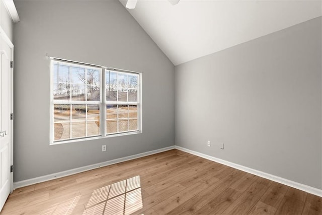 spare room featuring ceiling fan, high vaulted ceiling, and light hardwood / wood-style floors