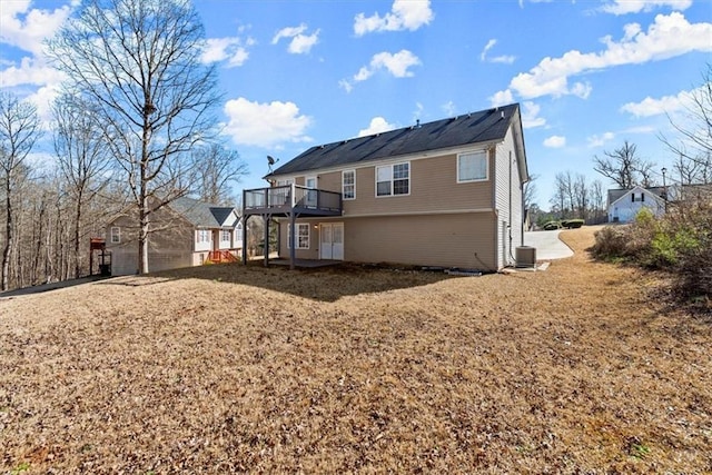 back of house with central AC and a deck