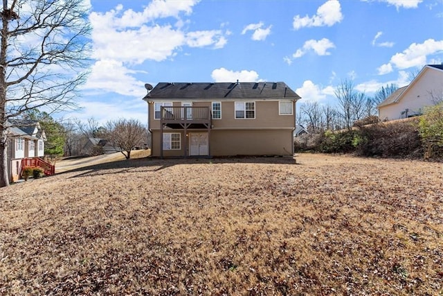 back of property featuring a balcony