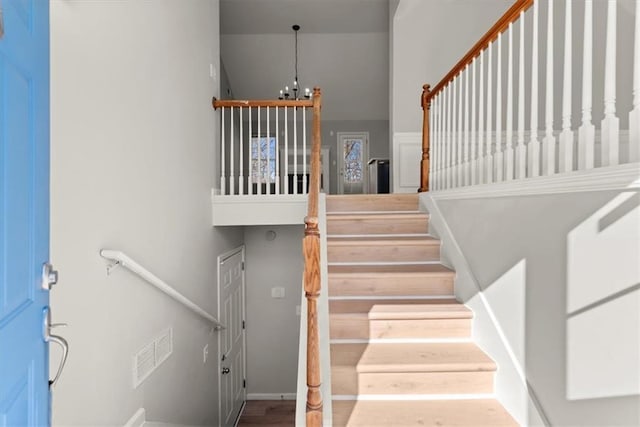 stairs with a chandelier