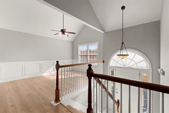 hallway featuring high vaulted ceiling and hardwood / wood-style floors