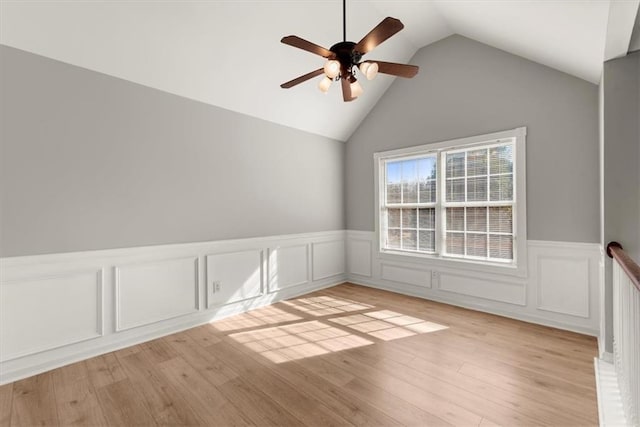 spare room with lofted ceiling, ceiling fan, and light hardwood / wood-style flooring