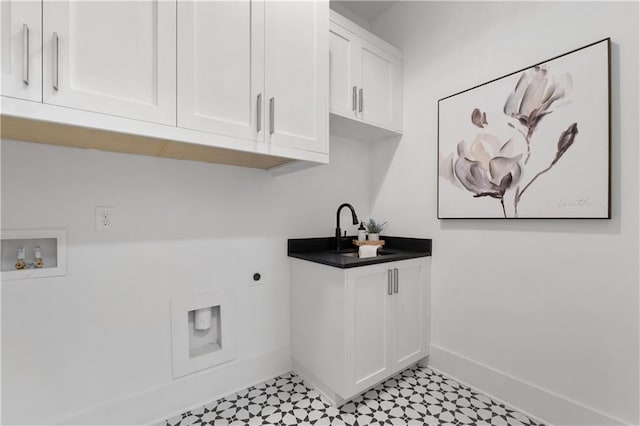 clothes washing area with electric dryer hookup, sink, hookup for a washing machine, and cabinets