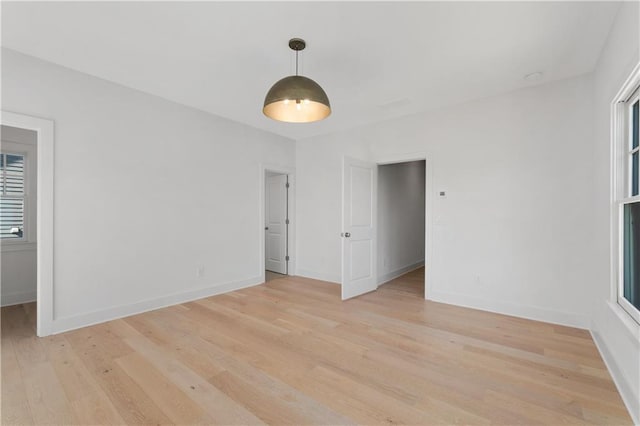 unfurnished room with light wood-type flooring