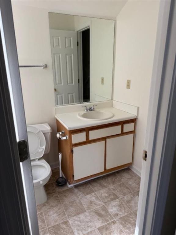 half bath featuring toilet and vanity