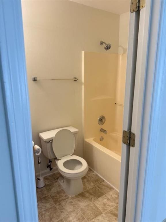 bathroom featuring bathtub / shower combination and toilet