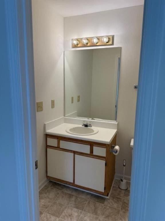 bathroom with toilet and vanity