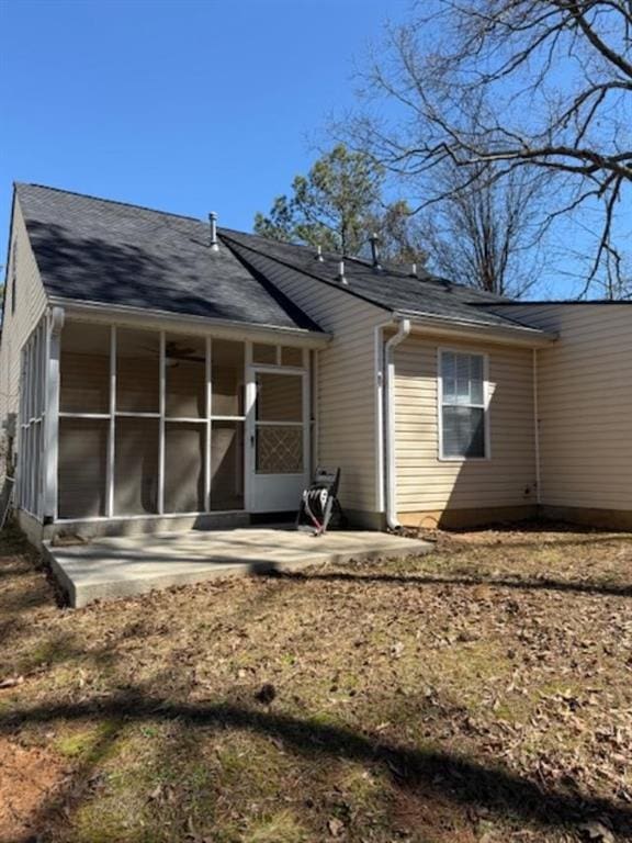 back of house with a sunroom and a patio area