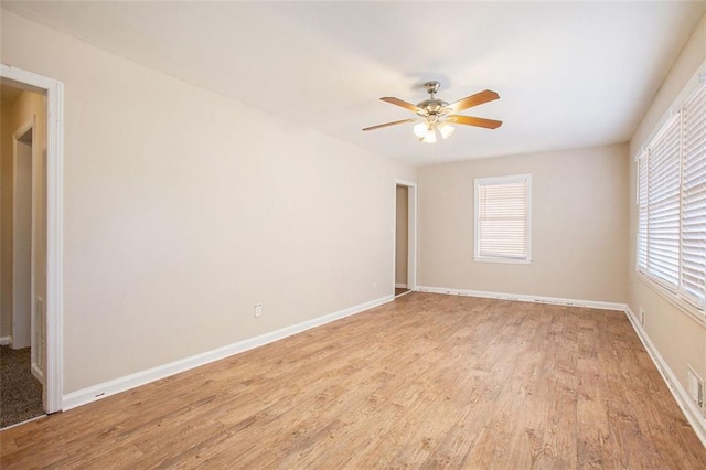 empty room featuring light hardwood / wood-style flooring and ceiling fan