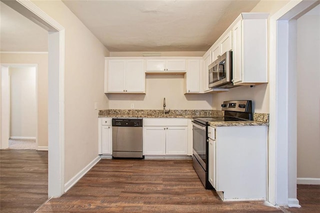 kitchen with sink, white cabinets, dark stone counters, and appliances with stainless steel finishes