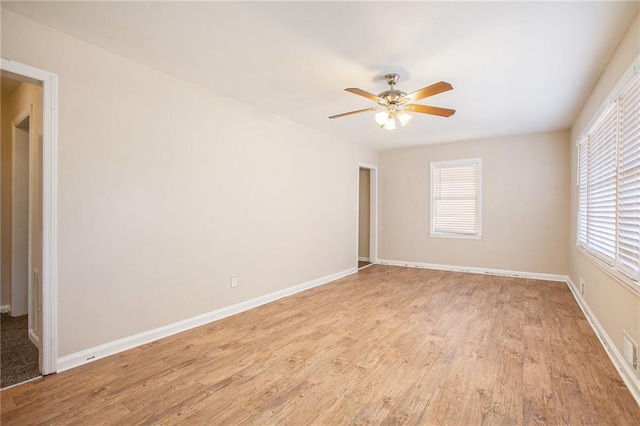 spare room featuring light hardwood / wood-style flooring and ceiling fan