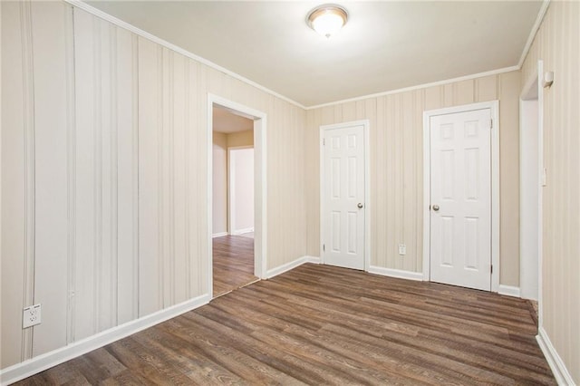 interior space with crown molding and dark wood-type flooring