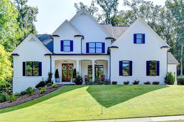 modern farmhouse style home with a front lawn and a porch