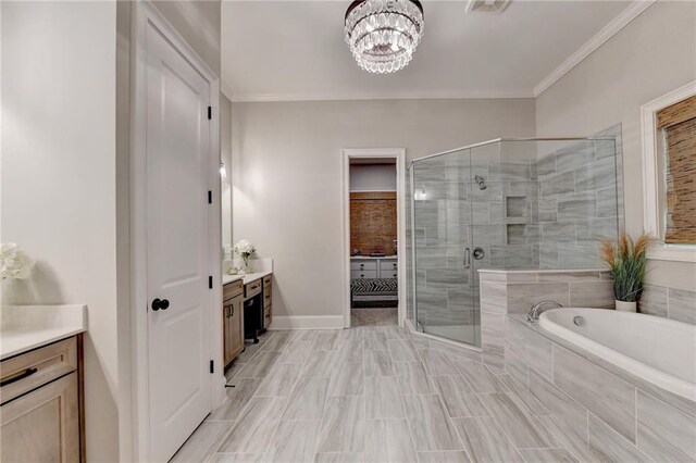 bathroom with vanity, an inviting chandelier, ornamental molding, and separate shower and tub