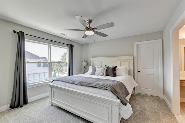 carpeted bedroom with connected bathroom and ceiling fan