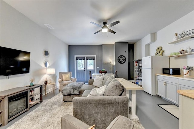 living room featuring french doors and ceiling fan