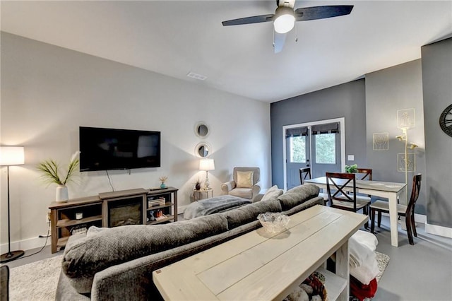 living room with concrete flooring and ceiling fan