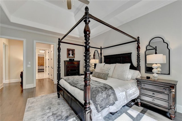 bedroom featuring hardwood / wood-style floors, crown molding, and ceiling fan