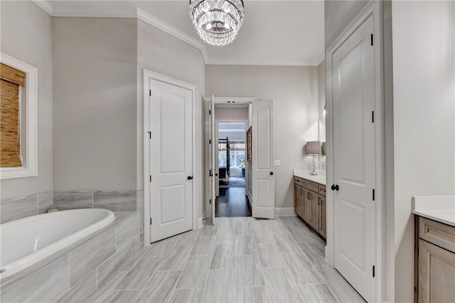 bathroom featuring a relaxing tiled tub, wood-type flooring, vanity, ornamental molding, and an inviting chandelier