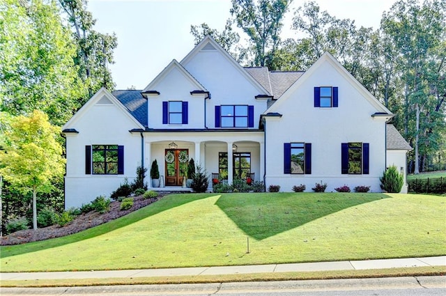 view of front facade with a front yard and covered porch