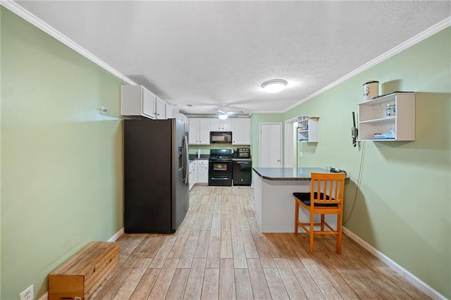 kitchen with ornamental molding, a breakfast bar, black appliances, light hardwood / wood-style floors, and white cabinetry