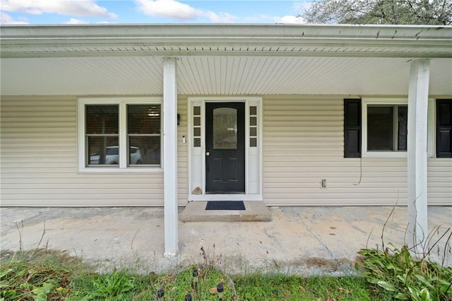 view of exterior entry with covered porch