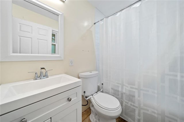 bathroom with vanity, toilet, and walk in shower