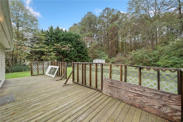 wooden deck featuring a storage shed