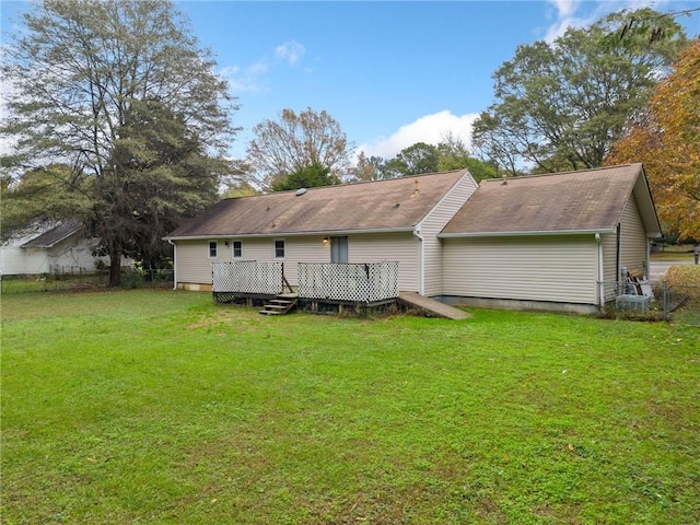 back of house featuring a yard and a deck