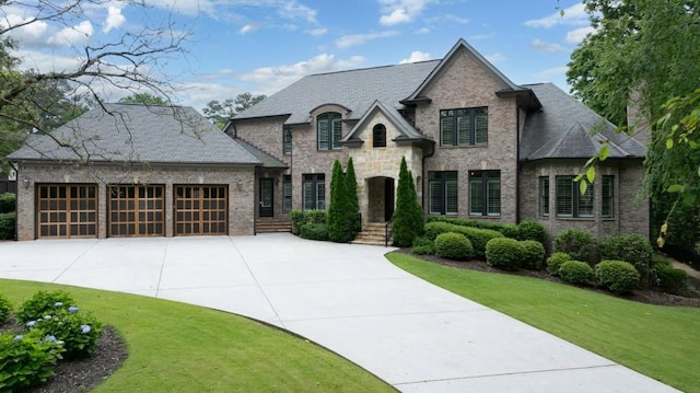 22 Mount Paran Rd, Atlanta, GA 30327 - french country home featuring driveway, an attached garage, brick siding, and a front lawn