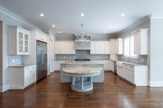 22 Mount Paran Rd, Atlanta, GA 30327 - kitchen with stainless steel appliances, a sink, a kitchen island with sink, white cabinetry, and decorative backsplash