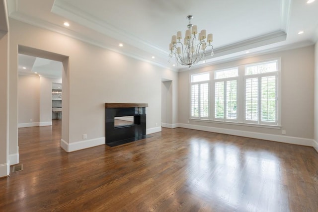 22 Mount Paran Rd, Atlanta, GA 30327 - unfurnished living room with crown molding, a chandelier, a raised ceiling, dark wood finished floors, and a glass covered fireplace