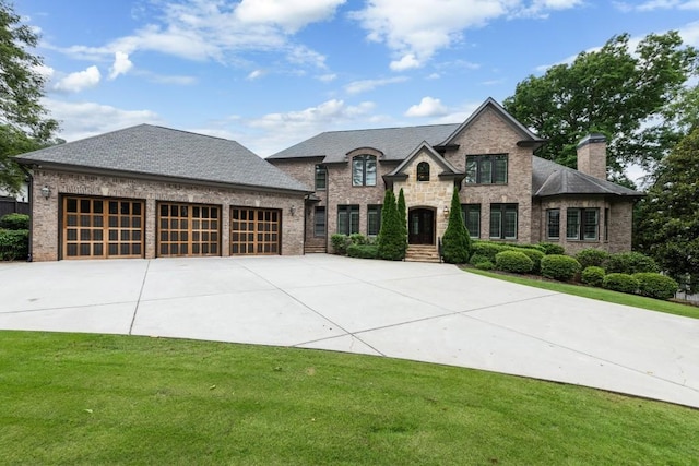 22 Mount Paran Rd, Atlanta, GA 30327 - french country style house with concrete driveway, a front yard, and brick siding