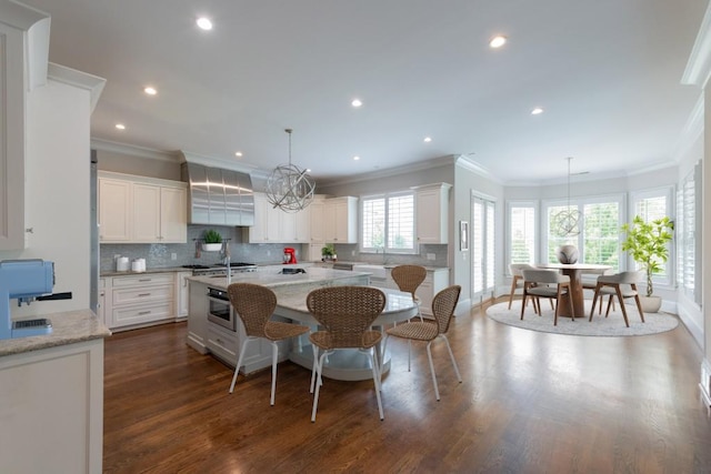 22 Mount Paran Rd, Atlanta, GA 30327 - kitchen featuring crown molding, a center island with sink, decorative backsplash, white cabinets, and a kitchen bar