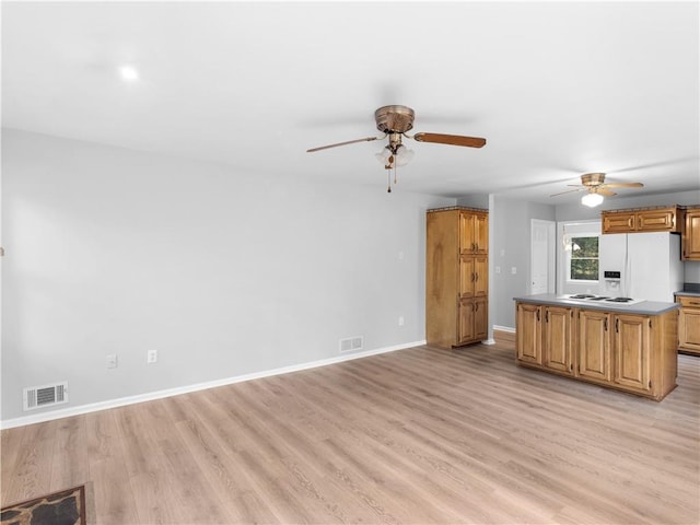 kitchen with a kitchen island, light hardwood / wood-style floors, and white appliances