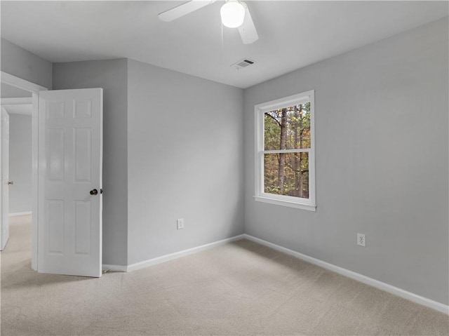 carpeted empty room featuring ceiling fan