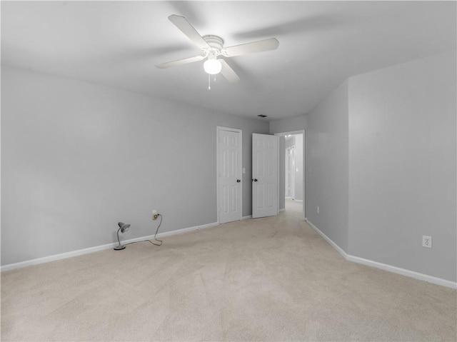 unfurnished room featuring ceiling fan and light colored carpet