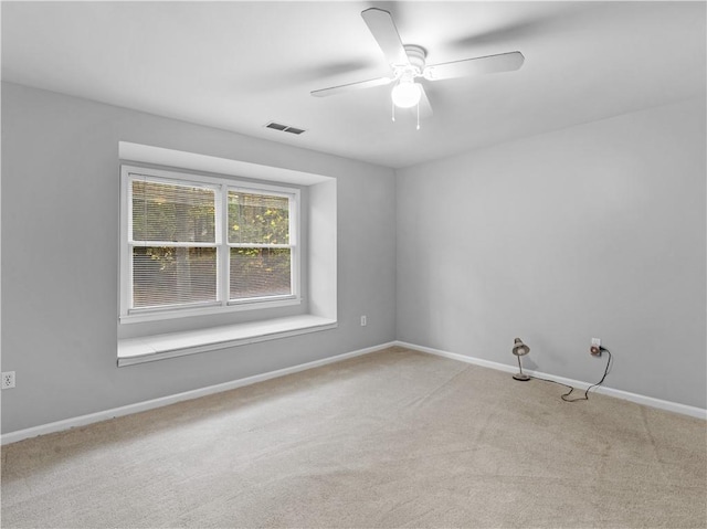 empty room with ceiling fan and light colored carpet